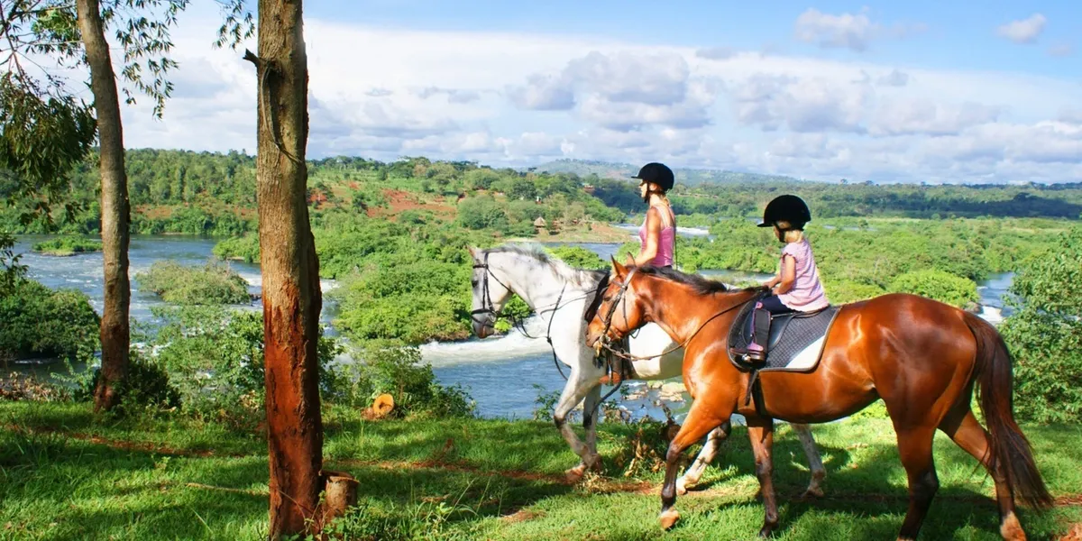 Two girls riding a horse