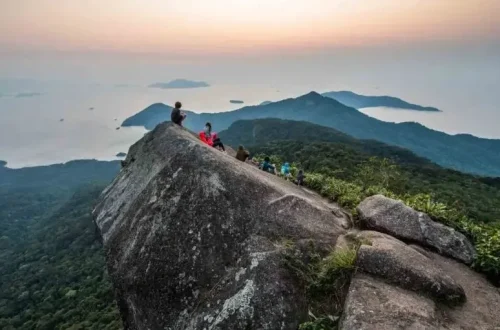 People sitting on top of a rock